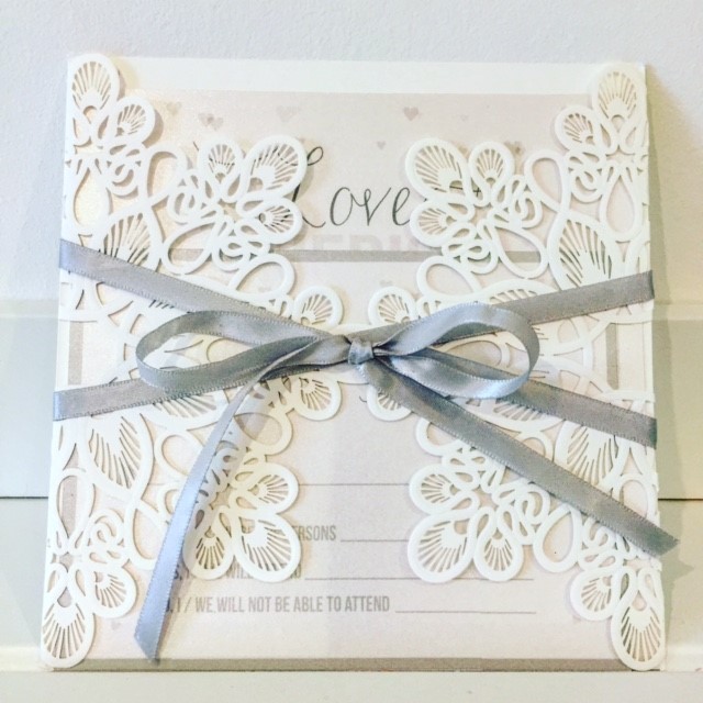 Handmade wedding invitation with ribbon detail